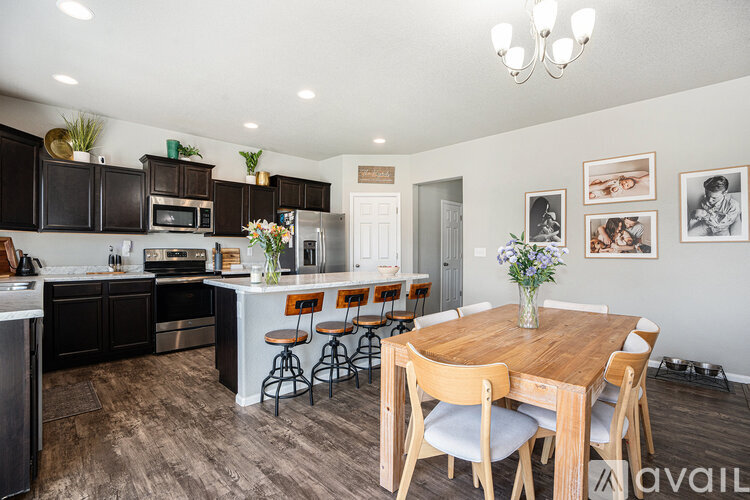 A kitchen with a table and chairs in the middle of the room.