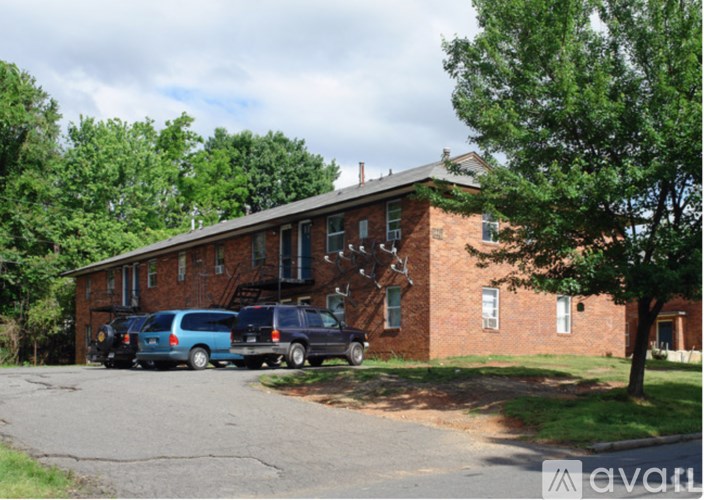 A brick building with a tree in front of it.