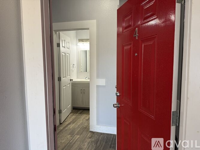 A kitchen with a refrigerator, microwave, oven, and cabinets.