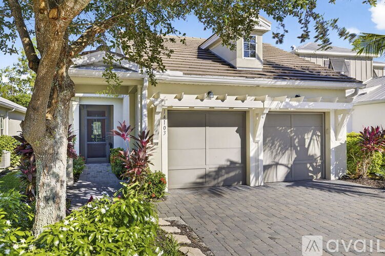 A house with a tree in front of it.