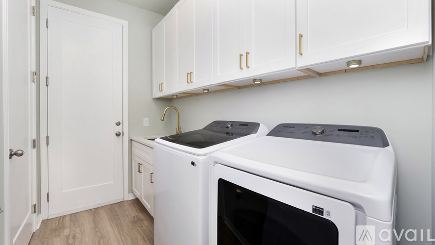 A white washing machine and dryer in a small laundry room.