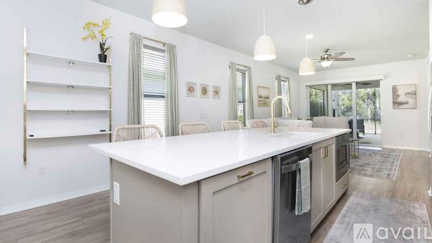 A kitchen with a white countertop and stainless steel appliances.