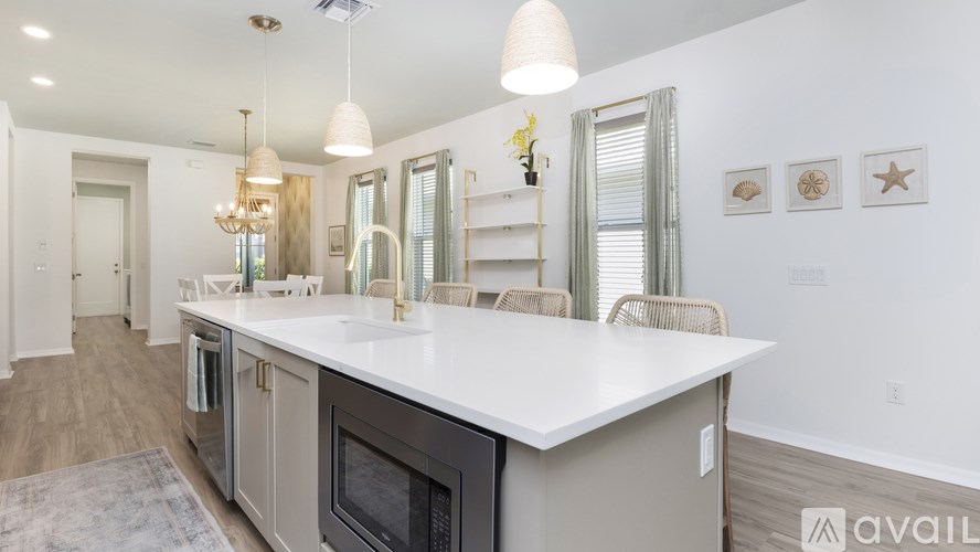 A modern kitchen with a large island and stainless steel appliances.