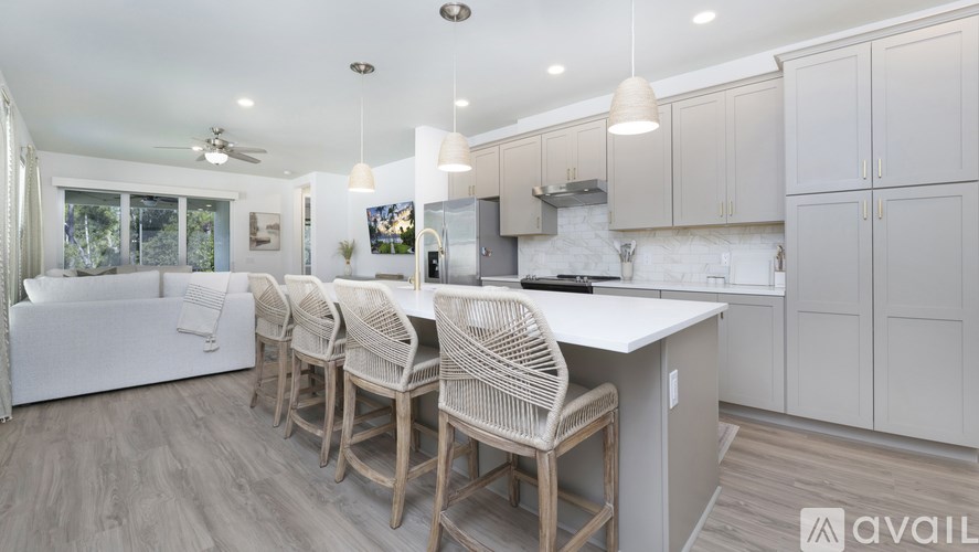 A kitchen with a dining table and chairs.