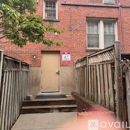 A brown door with a sign above it.
