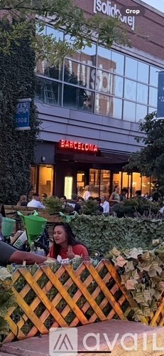A woman is sitting at a table outside a Solidaridad Crop building.