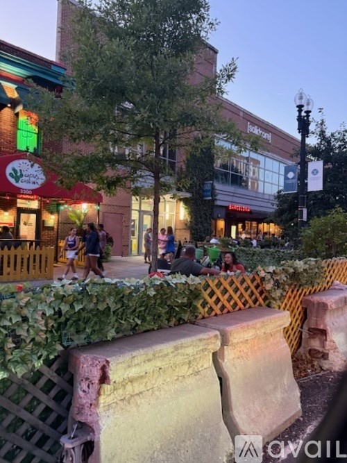 A street view with a building and people walking.