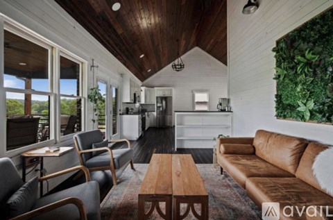 A living room with a brown couch and a wooden coffee table.