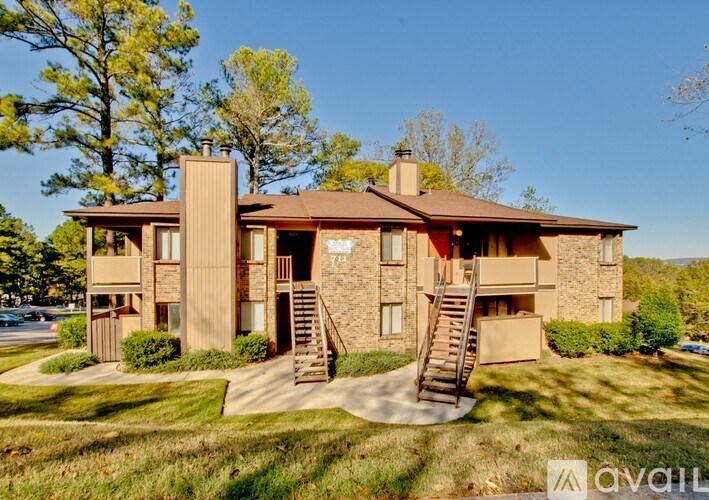 A two-story building with a brown roof and a stone facade.