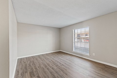 A dining room with a table and chairs.