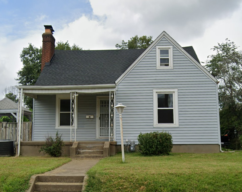 A small house with a porch and a front door.