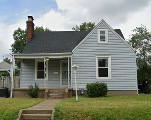 A small house with a porch and a front door.