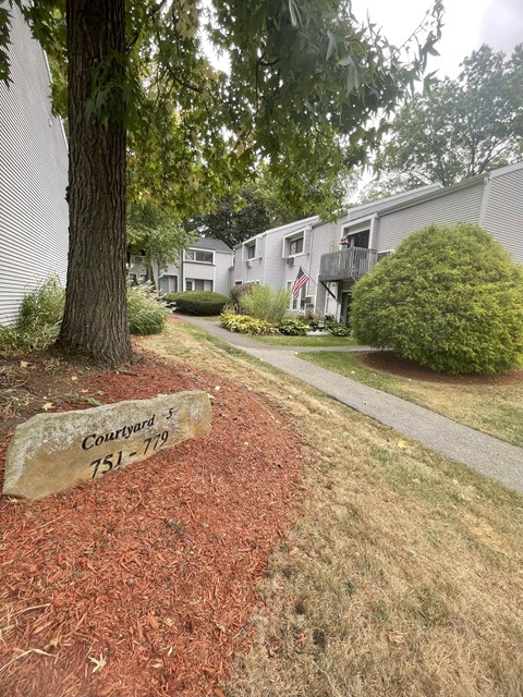 A sign in front of a tree reads "Courtyard 751-779".