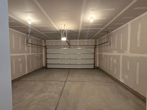 A spacious room with a long shelf and fluorescent lights.