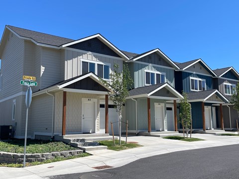 A row of houses with a stop sign in front of them.