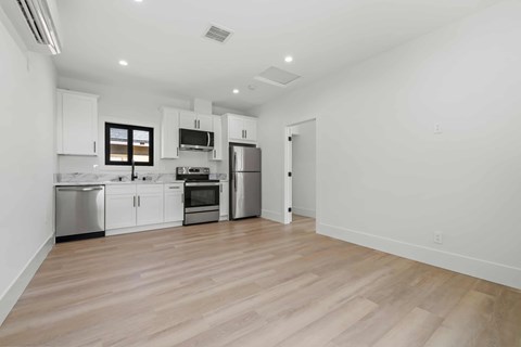 A kitchen with white cabinets and stainless steel appliances.