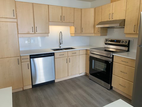 A kitchen with wooden cabinets and stainless steel appliances.