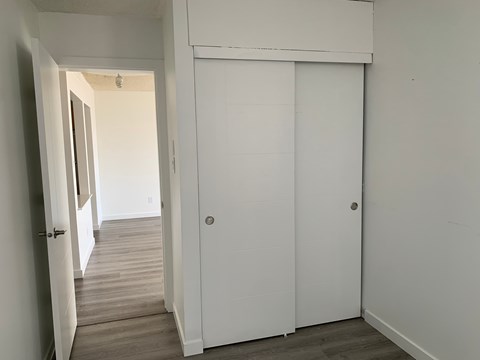 A white door is in a room with white walls.