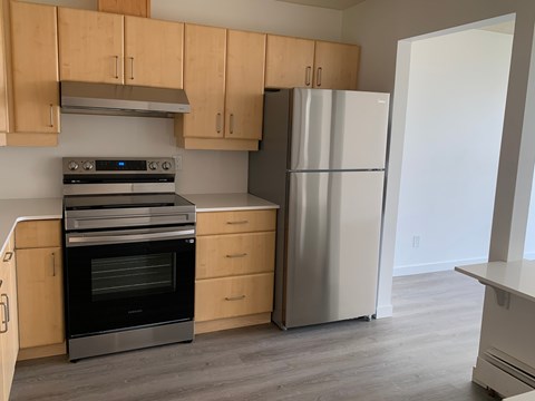 A kitchen with a stove, oven, and refrigerator.
