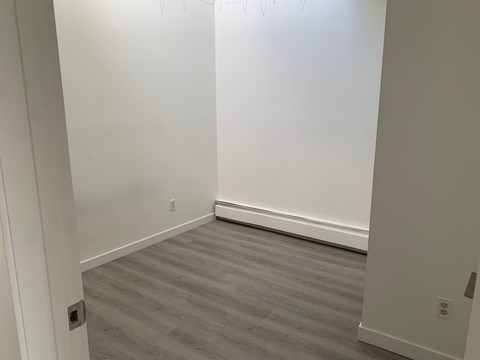 A room with a grey floor and white walls.
