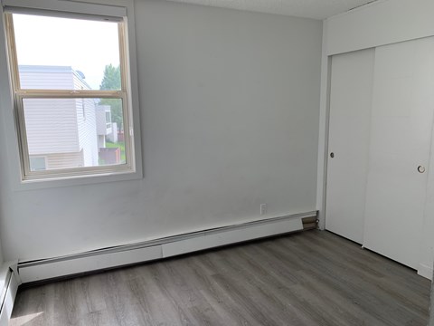 A room with a window and a door.