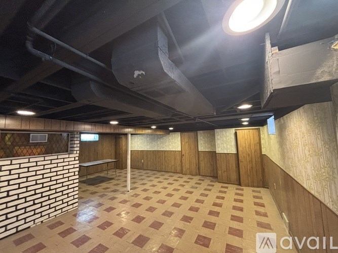 A room with a brick wall and tiled floor.