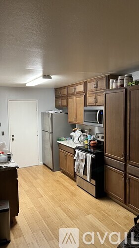 A kitchen with wooden cabinets and a black countertop.