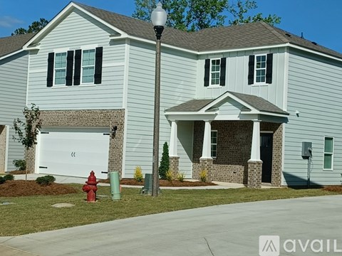 A house with a red fire hydrant in front of it.