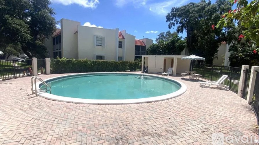 A small pool surrounded by a brick patio.