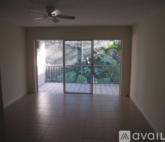 A room with a sliding glass door leading to a patio.