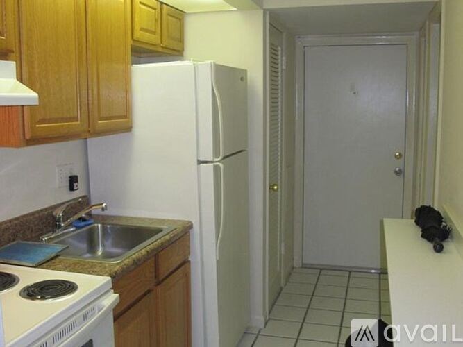 A kitchen with a white refrigerator and a white stove.