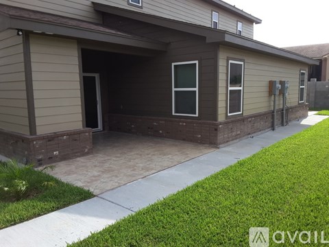 A house with a brown and beige exterior and a white door.