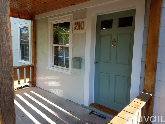 A white house with a blue door and a window.