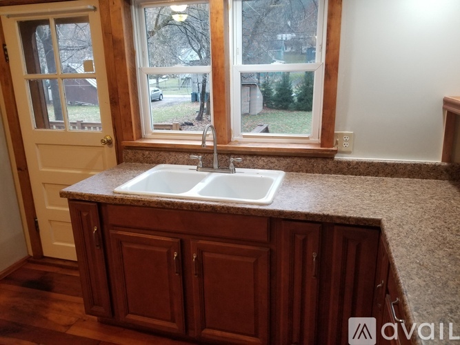 A kitchen with a sink and cabinets.