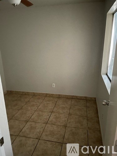 A room with a tiled floor and a ceiling fan.