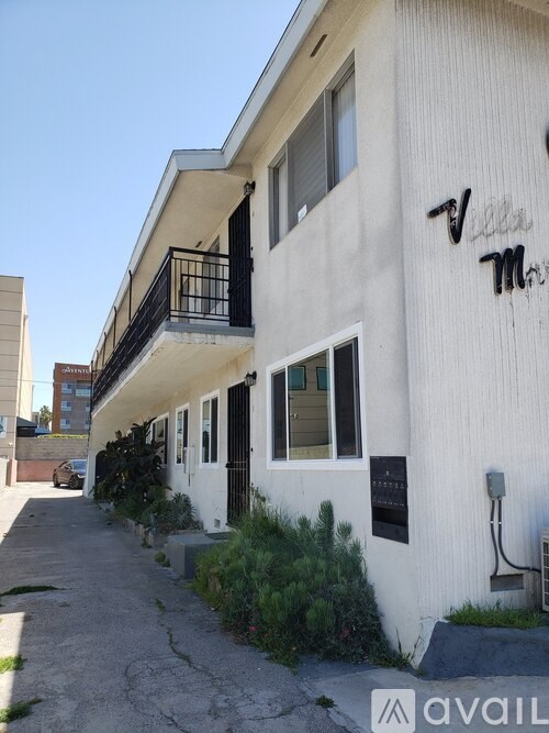 A white building with the word "Villas" written on it.