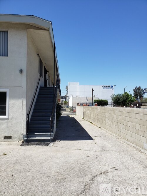 A concrete building with a staircase leading to the second floor.