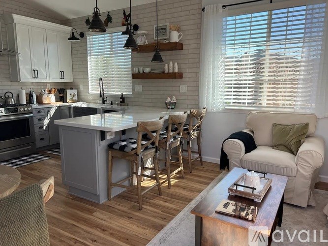 A kitchen with a white countertop and a grey island.