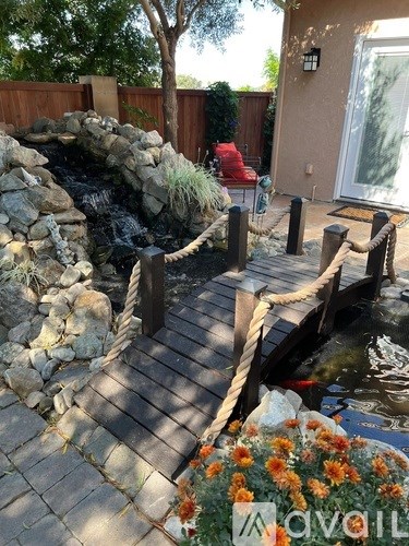 A wooden dock with a rope tied to it.