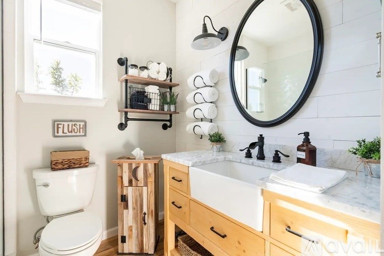 A bathroom with a white toilet, wooden storage, and a marble countertop.