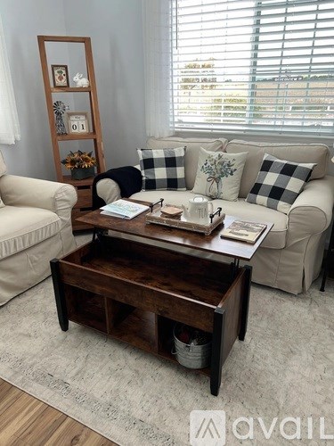 A living room with a wooden coffee table in the center.