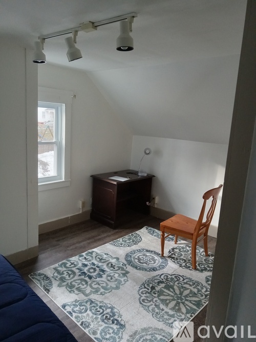 A room with a desk and a chair.