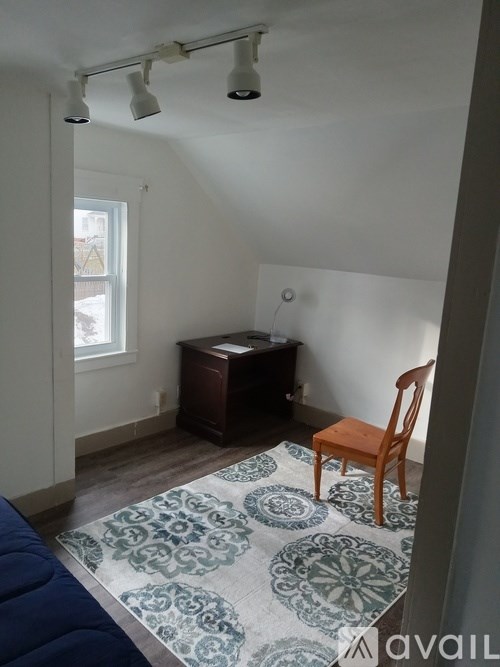 A room with a desk and a chair.