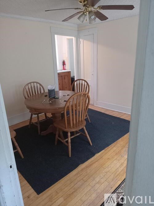A dining room with a table and chairs.