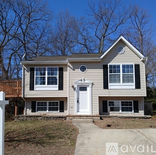 A house with a white door and windows is for sale.
