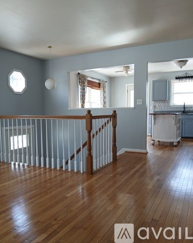 A room with wooden floors and a staircase.