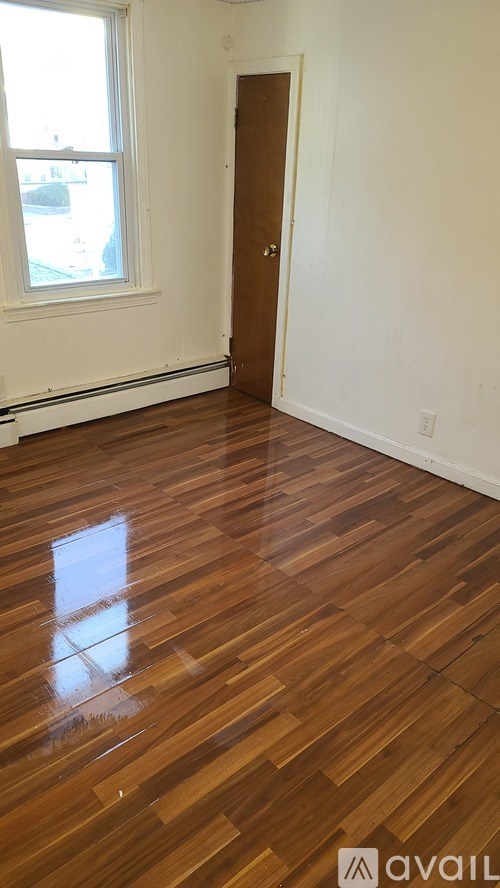 A room with a wooden floor and a door.