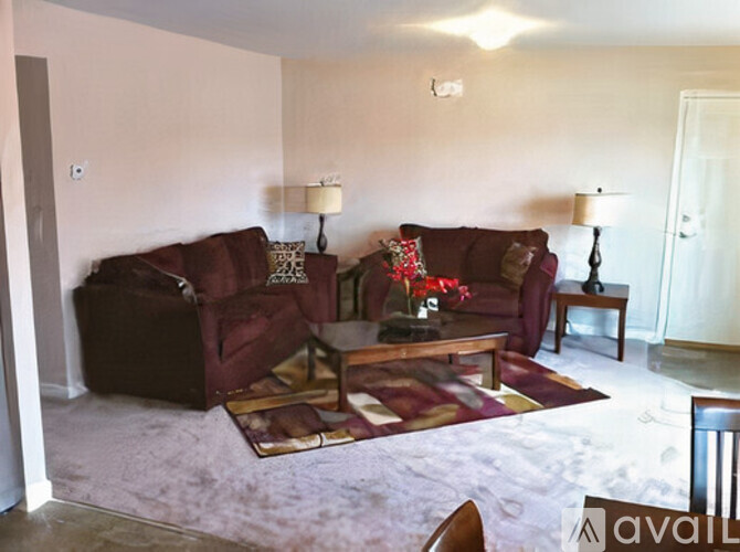 A living room with a red couch and a coffee table.