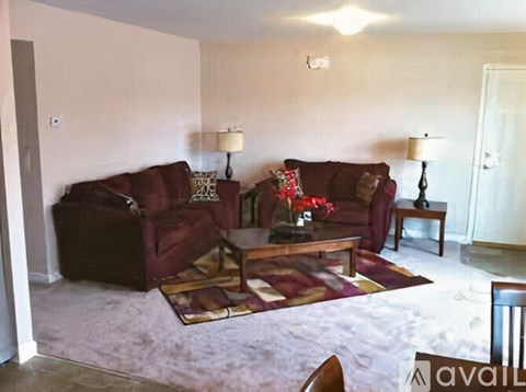A living room with a red couch and a coffee table.