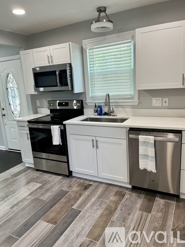 A kitchen with a stove top oven, microwave, and dishwasher.
